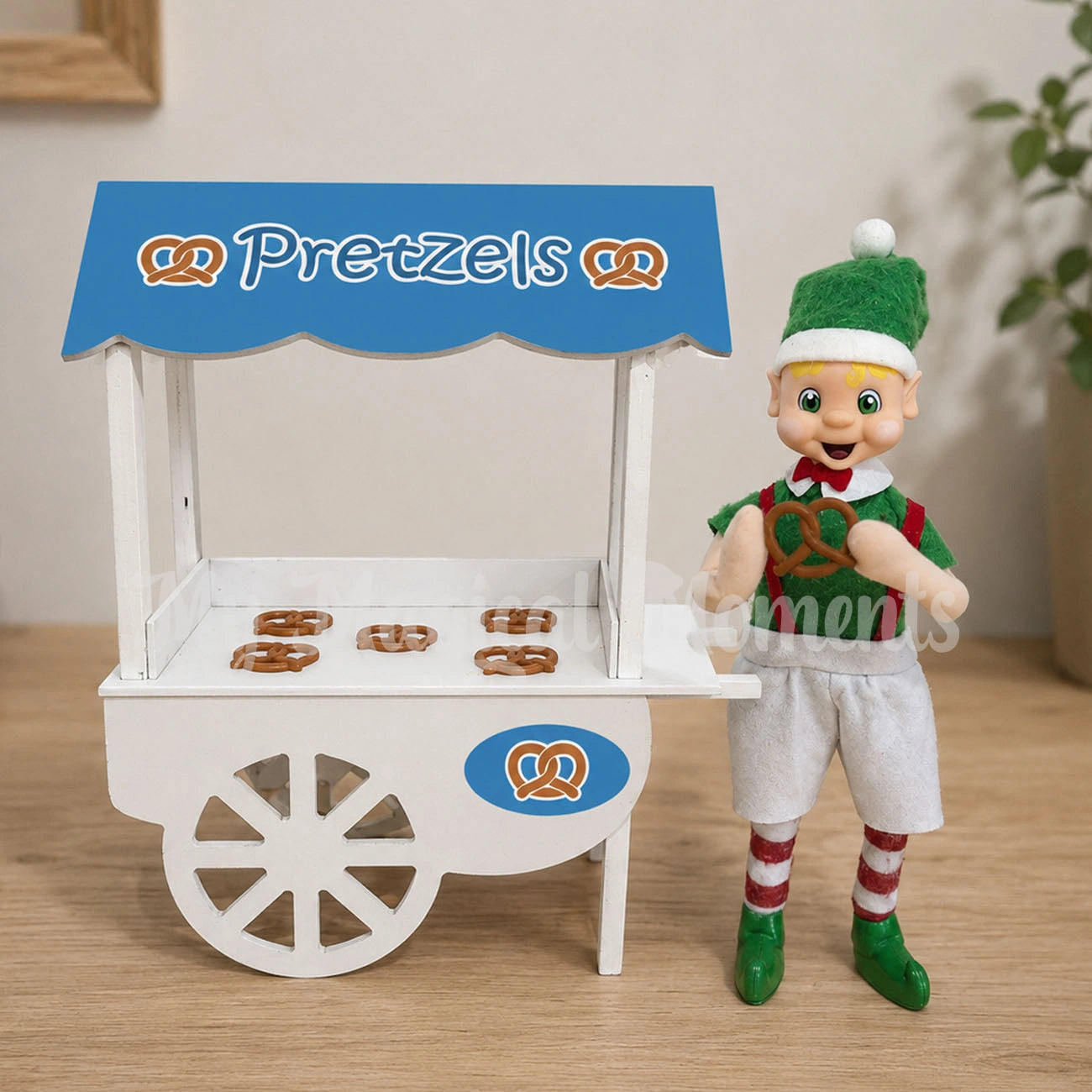 Elf set up with a pretzel stand and an elf holding a miniature pretzel prop
