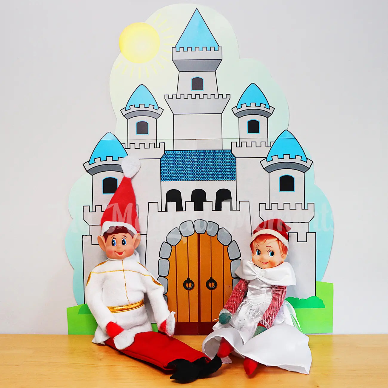 elves dressed in prince & princess costumes in front of a printable castle