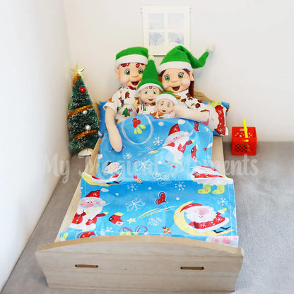 A family of elves wearing pyjamas in an elf bed 