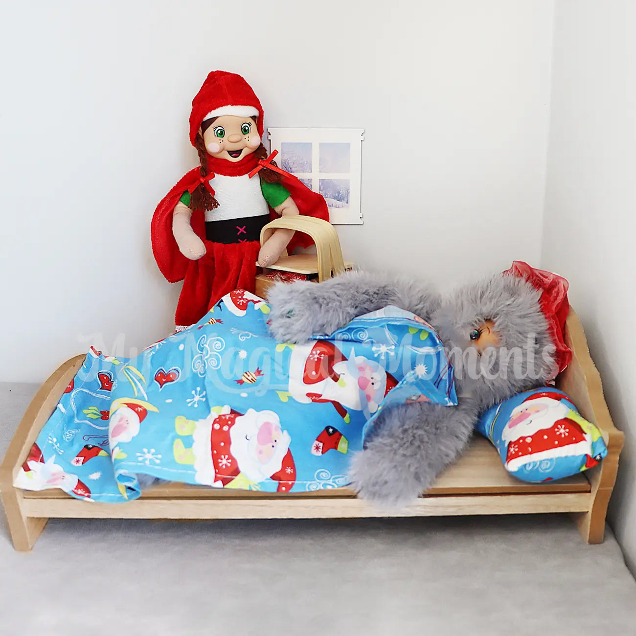 elf dressed as a wolf hiding in bed with red riding hood dressed elf