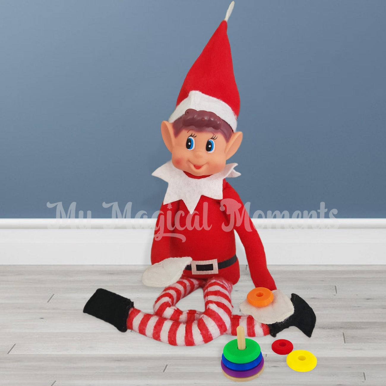 Elves behavin badly playing with a miniature ring stacker toy