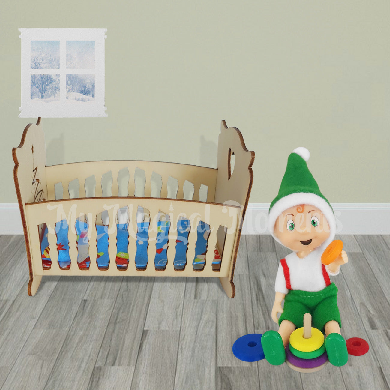 Elf toddler playing with mini ring stacker toy in room with cot