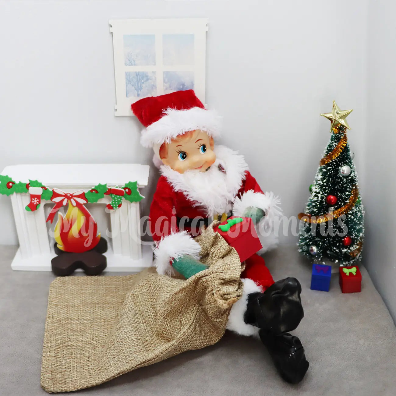 Elf dressed as Santa delivering presents under the Christmas tree