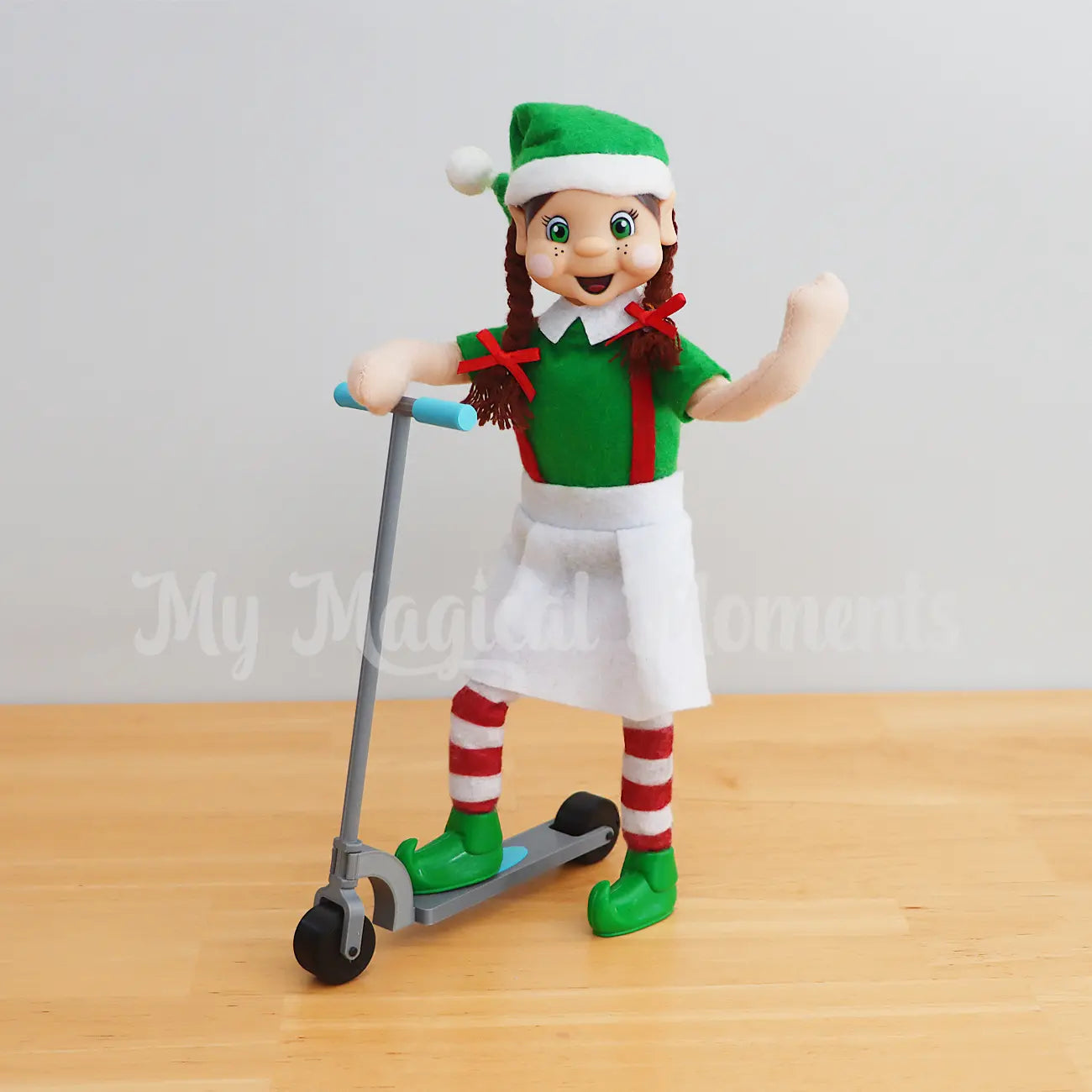 Elf friends standing on a mini scooter