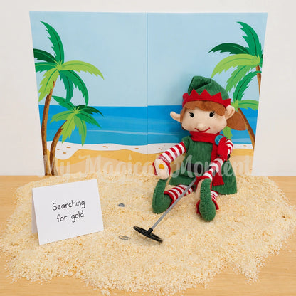 Elf sitting on a pile of bread crumb sand, with a beach background printable. Holding a metal detector looking for gold. The sign says searching for gold