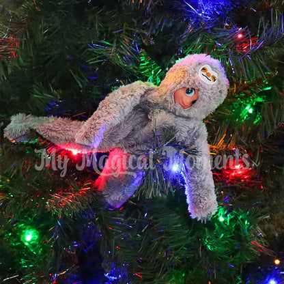 elf wearing a sloth costume in a tree