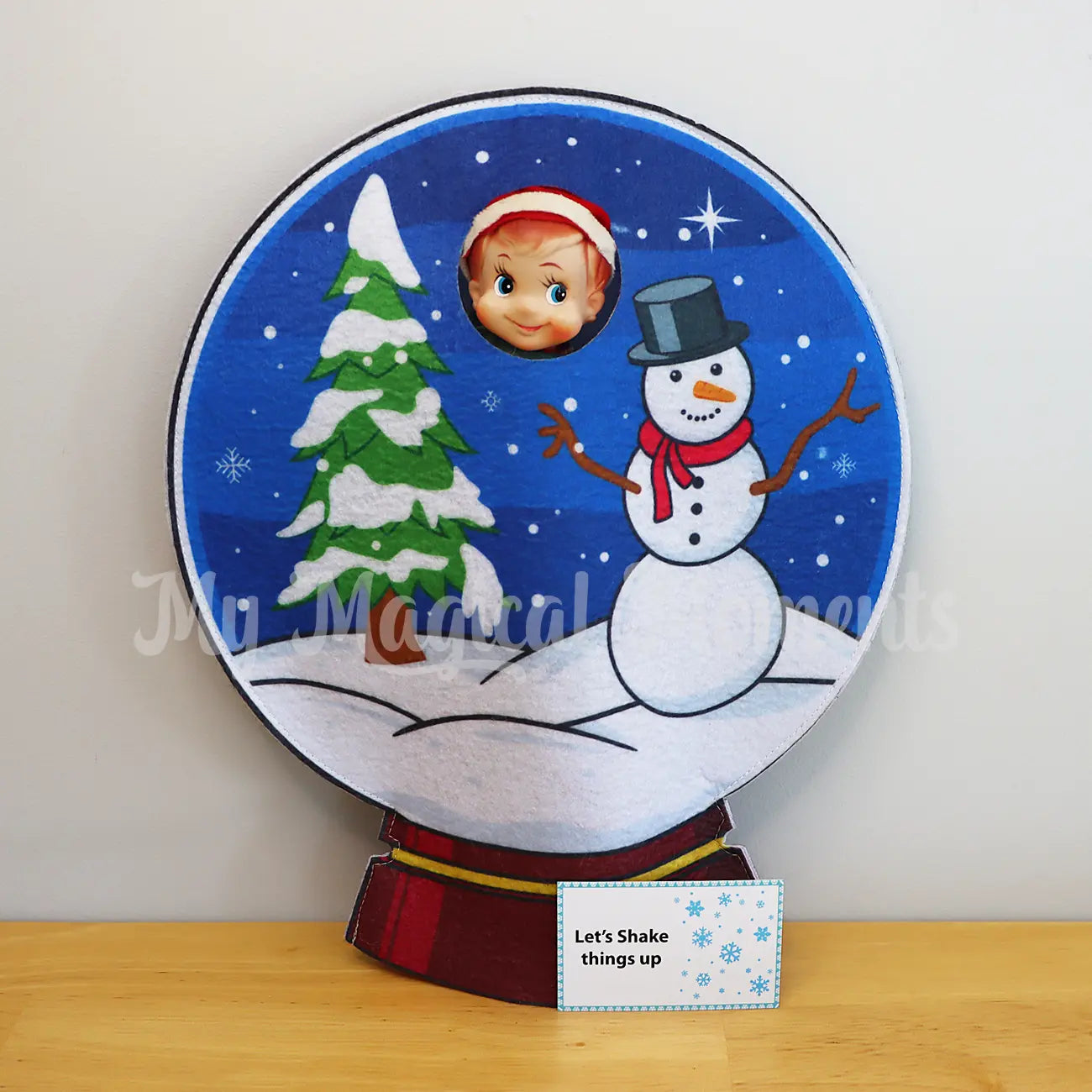 elf wearing a snow globe costume