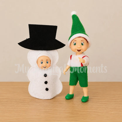 elf toddler with a baby dressed as a snowman