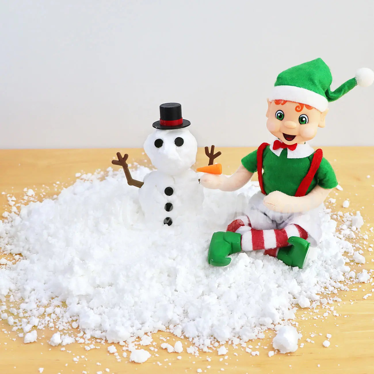 Orange hair My Elf Friends building a snowman with  a melting snowman prop with fake snow