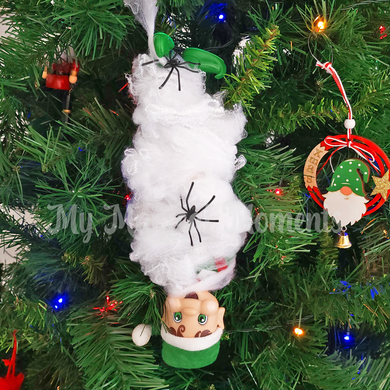 Elf stuck upside down caught in a spider web prop