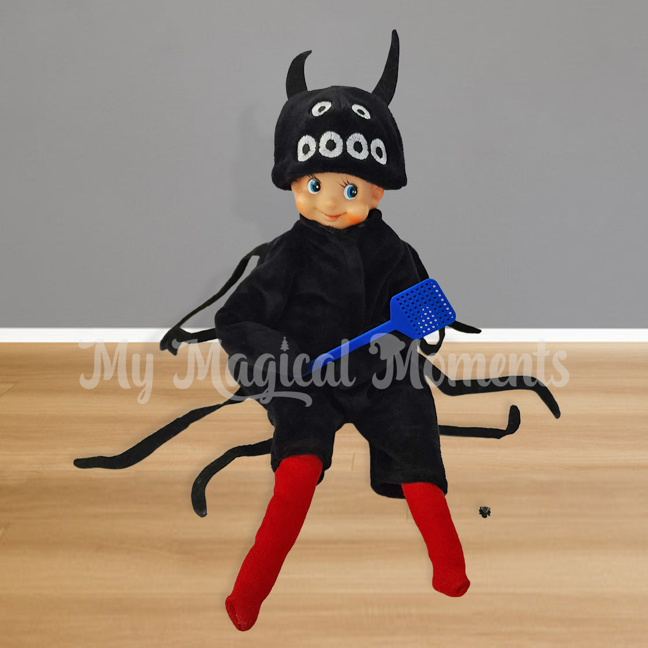 60s elf dressed in a spider costume holding a fly swatter and a fly prop