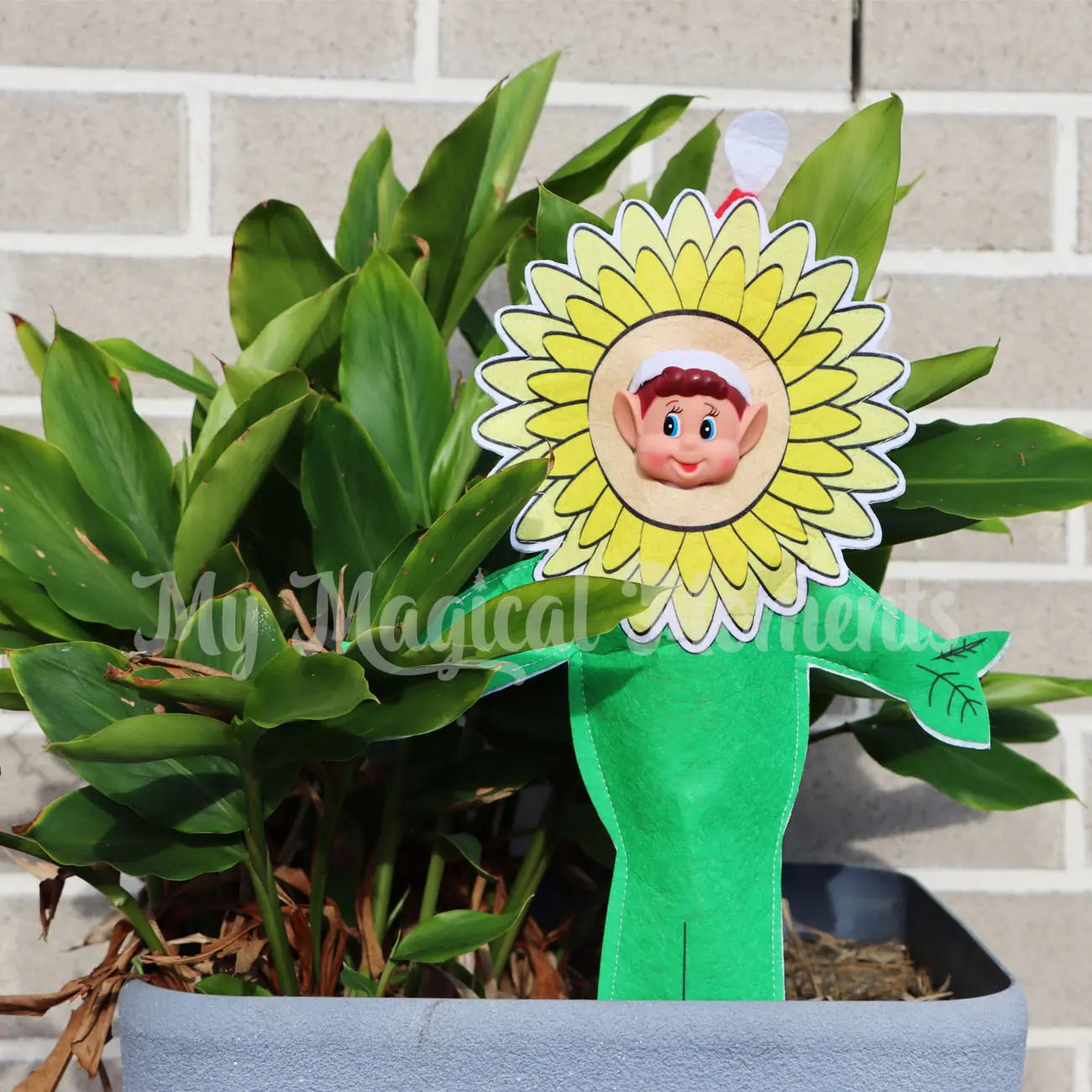 elves behavin badly elf wearing a sunflower costume in a pot