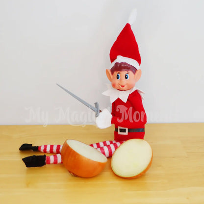 Elf using a mini sword prop to cut an onion