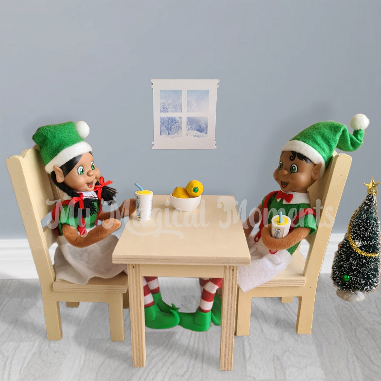 Black hair elves having lemonade on a wooden table