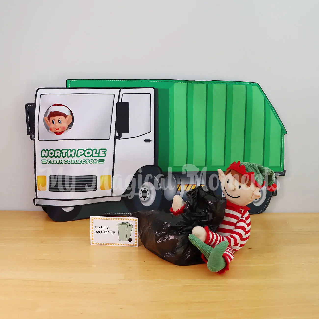 Elf taking out trash with an elf dressed in a garbage truck outfit