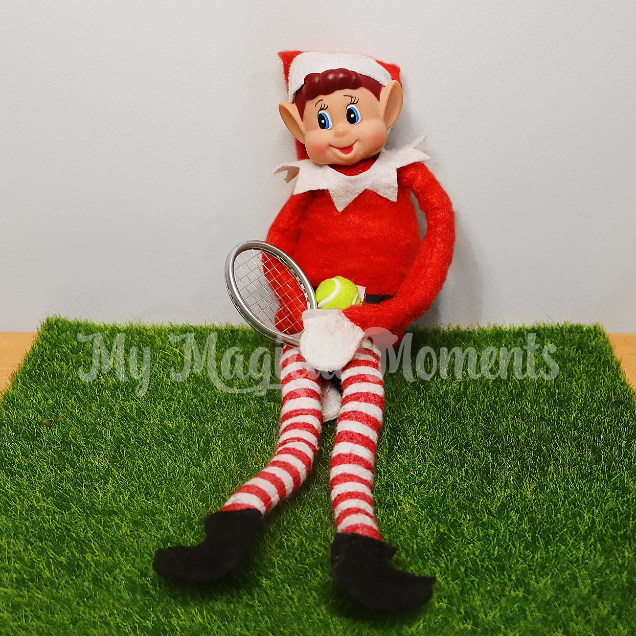 elf ready to play tennis with a mini tennis set