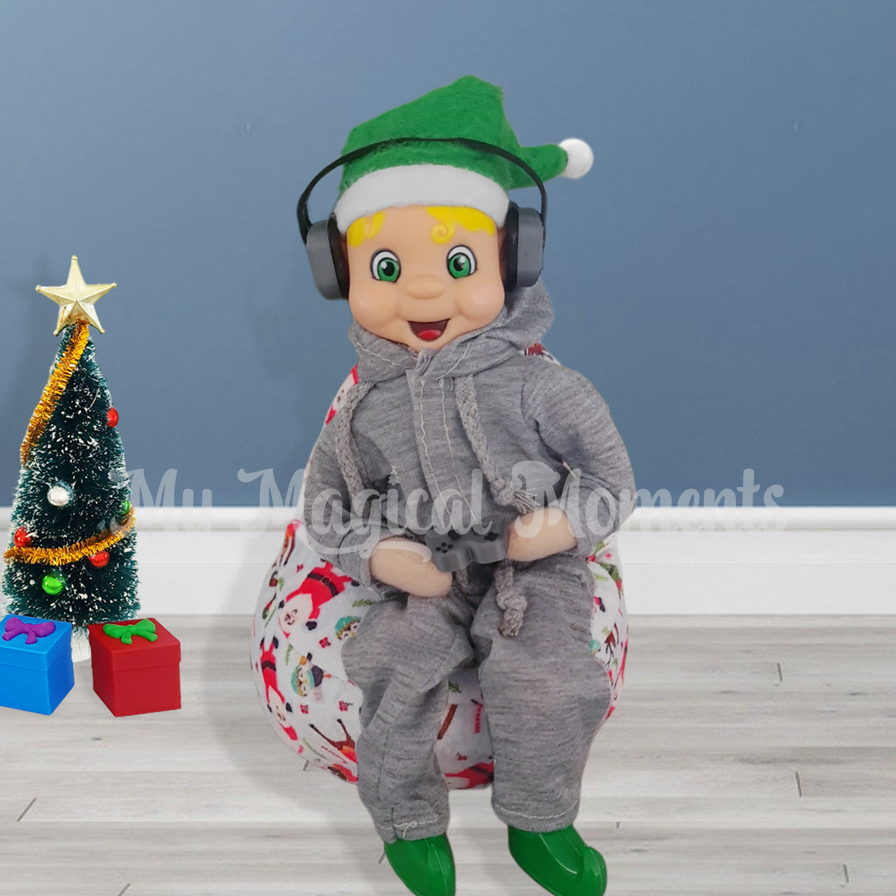 Elf wearing trackies and headphones. Sitting on a miniature bean bag playing a game