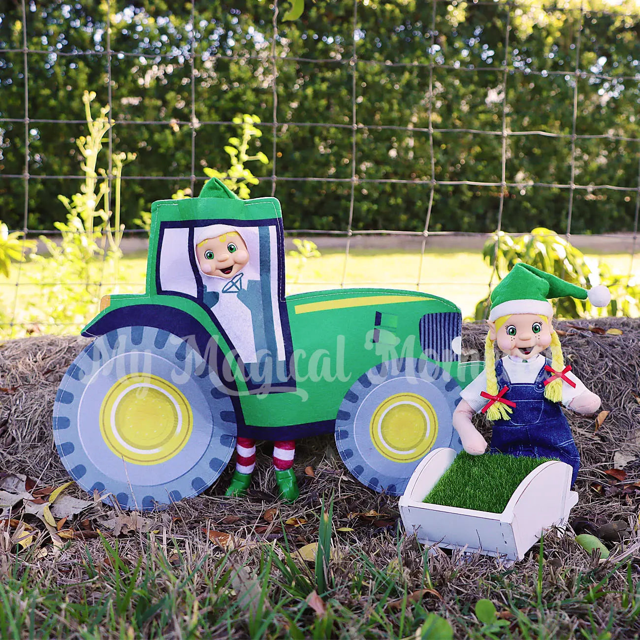 elf wearing a tractor costume farming with an elf in overalls with mini wheelbarrow