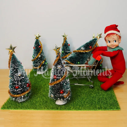 elf shopping for Christmas trees with a miniature trolley prop