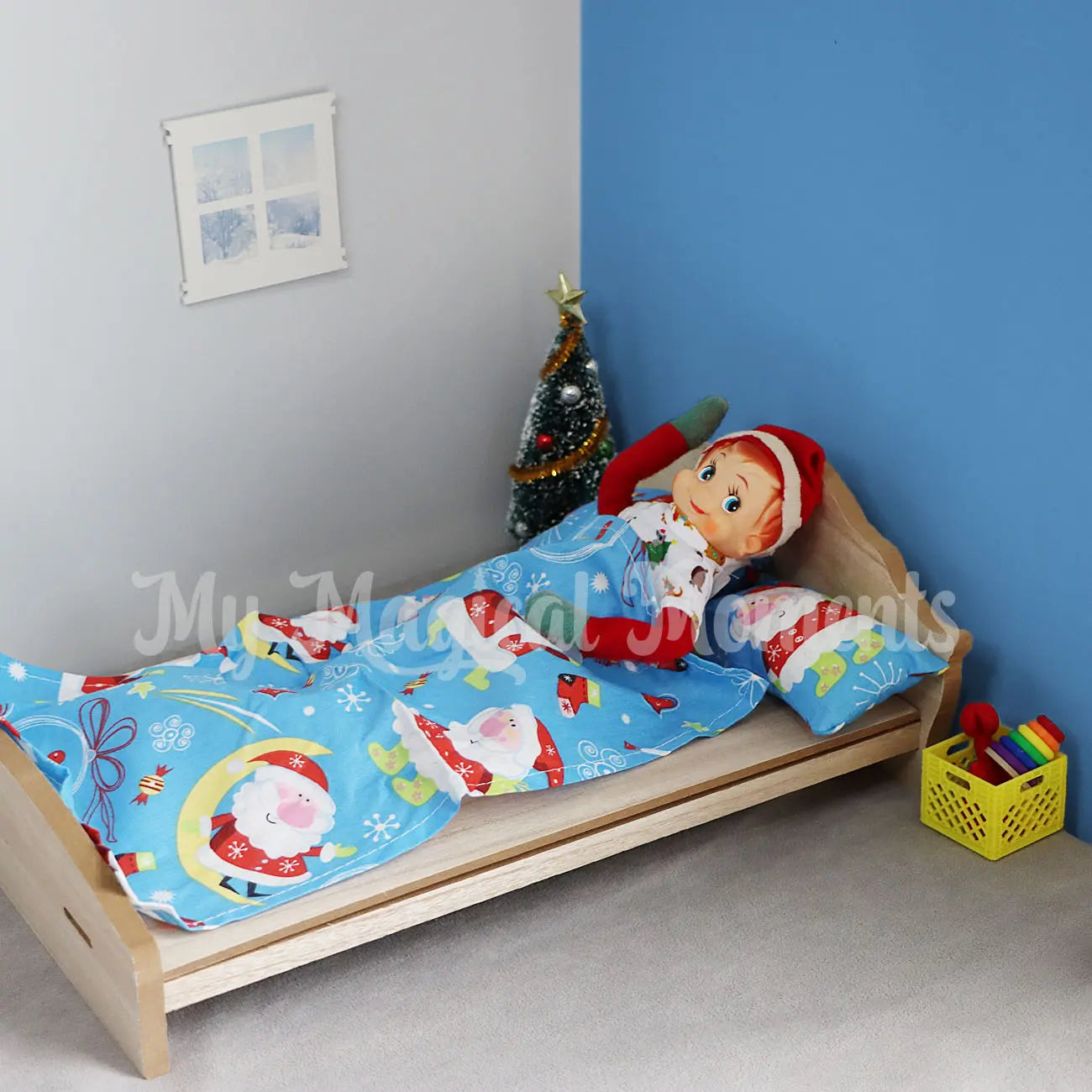 elf laying in a wooden bed dressed in pjs in an elf house with elf furniture
