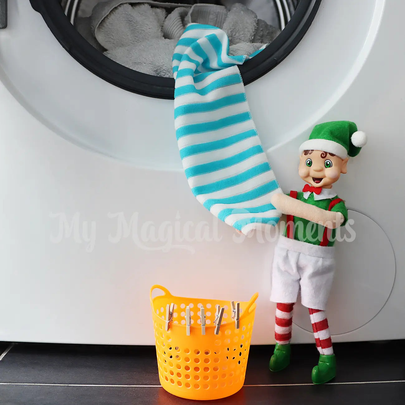 elf doing the laundry with mini towel and mini washing basket