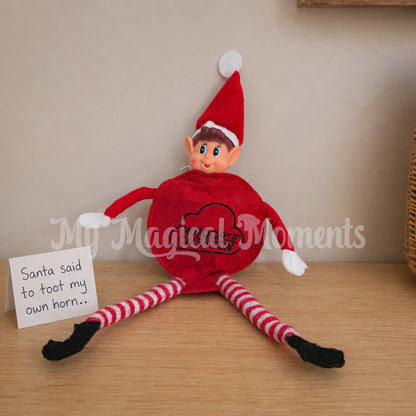 elf wearing a whoopie cushion, a hand written note saying, Santa said to toot my own horn