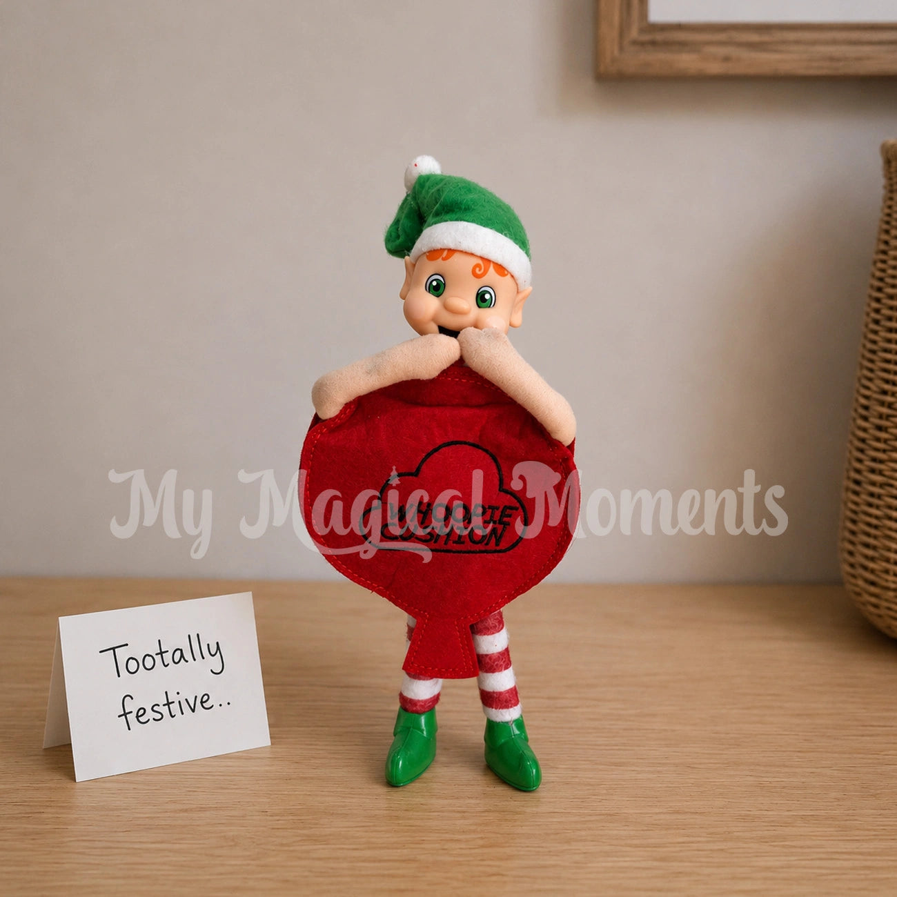 elf wearing a whoopie cushion costume standing laughing with a note saying tootally festive