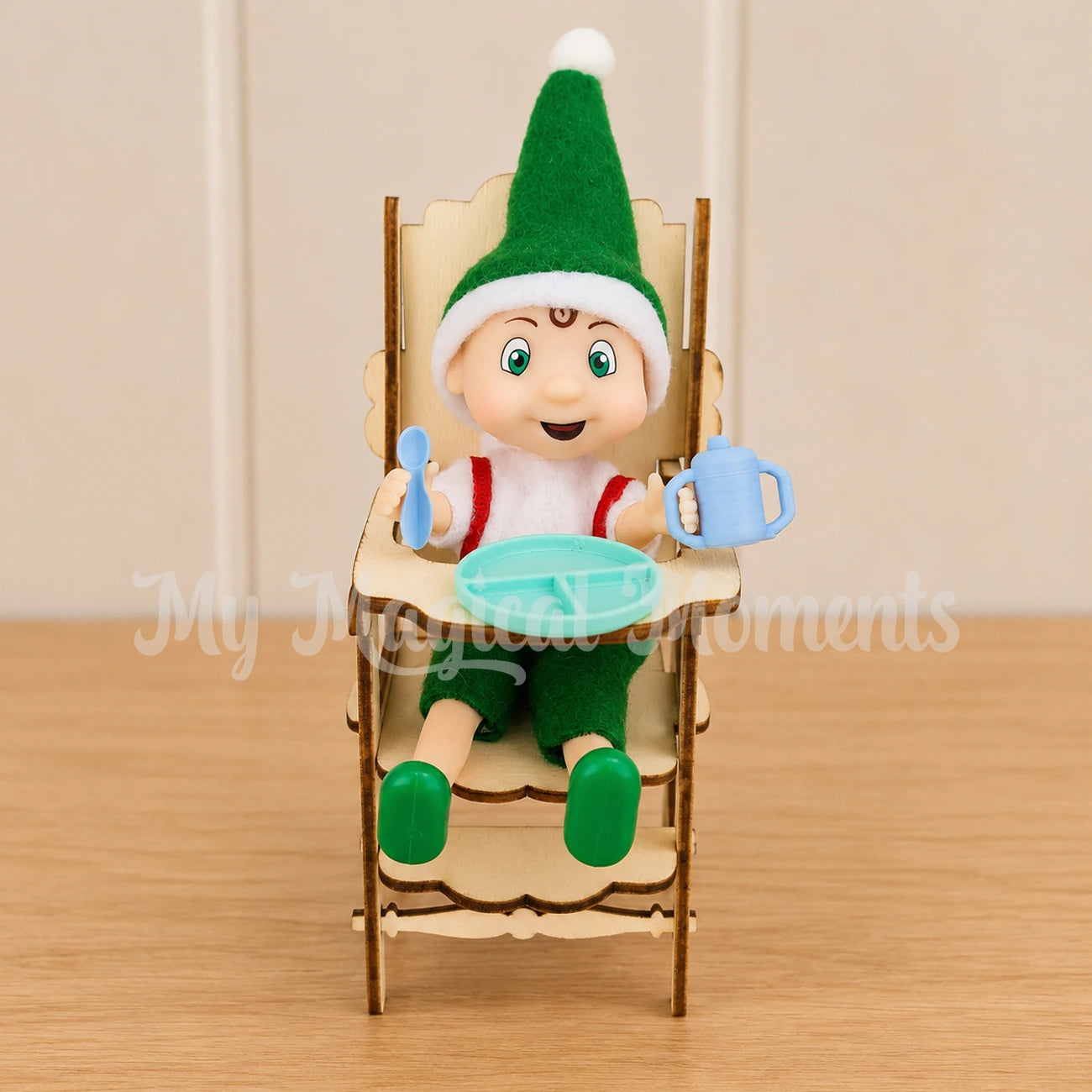 elf toddler sitting in a mini high chair with a tiny feeding set, plate spoon and sippy cup