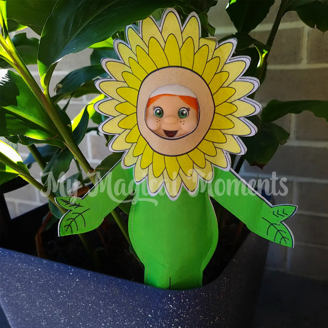 Elf dressed as a sunflower in a pot plant