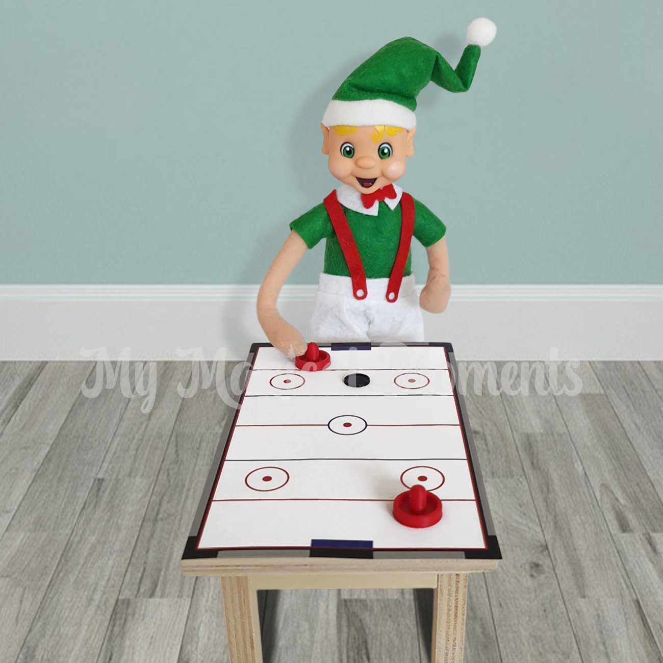 Blonde hair elf playing air hockey on a table with red pushes and a puck
