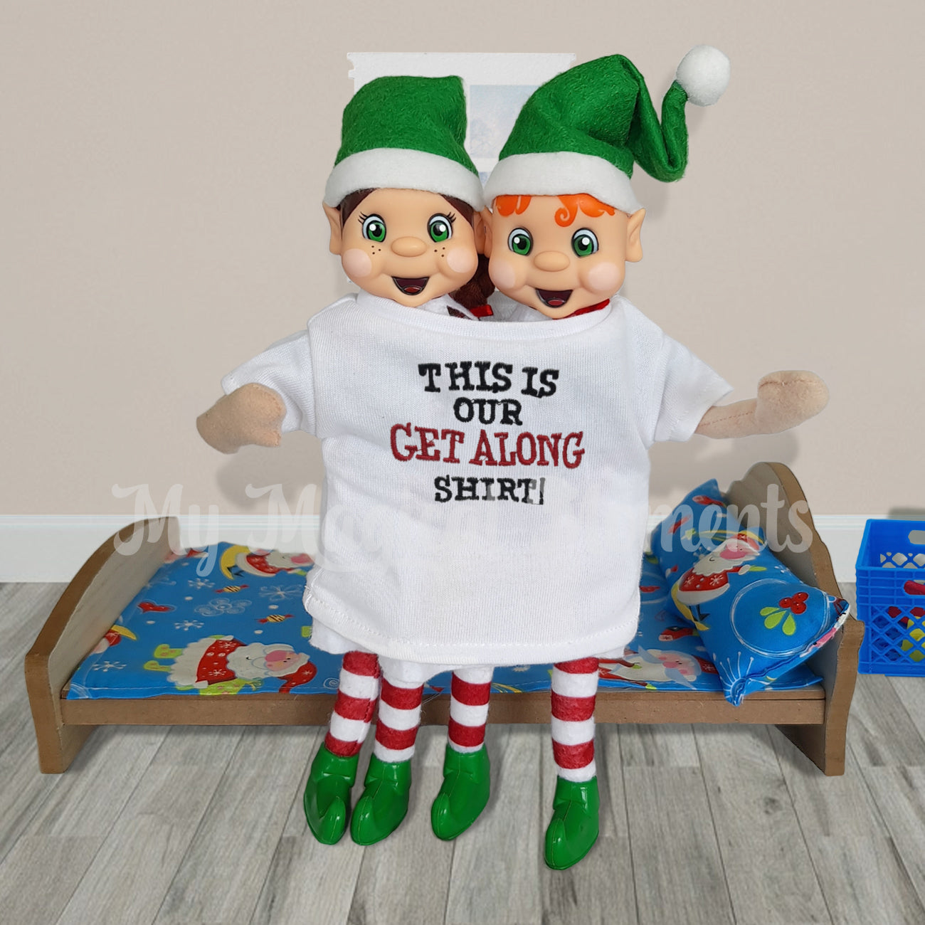 My elf friends forced to get along in a shared shirt. in front a miniature bed