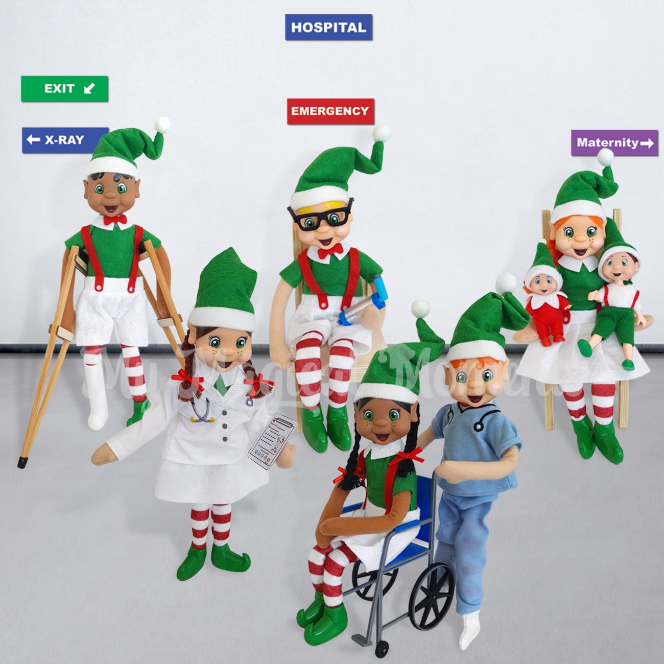 Elf Hospital Scene, with free printable hospital signs. Emergency, x-ray and maternity. One elf has a broken leg, another is having an asthma attack. A mum elf has her elf baby and elf toddler. A elf dressed as a nurse is pushing an elf in a blue wheelchair