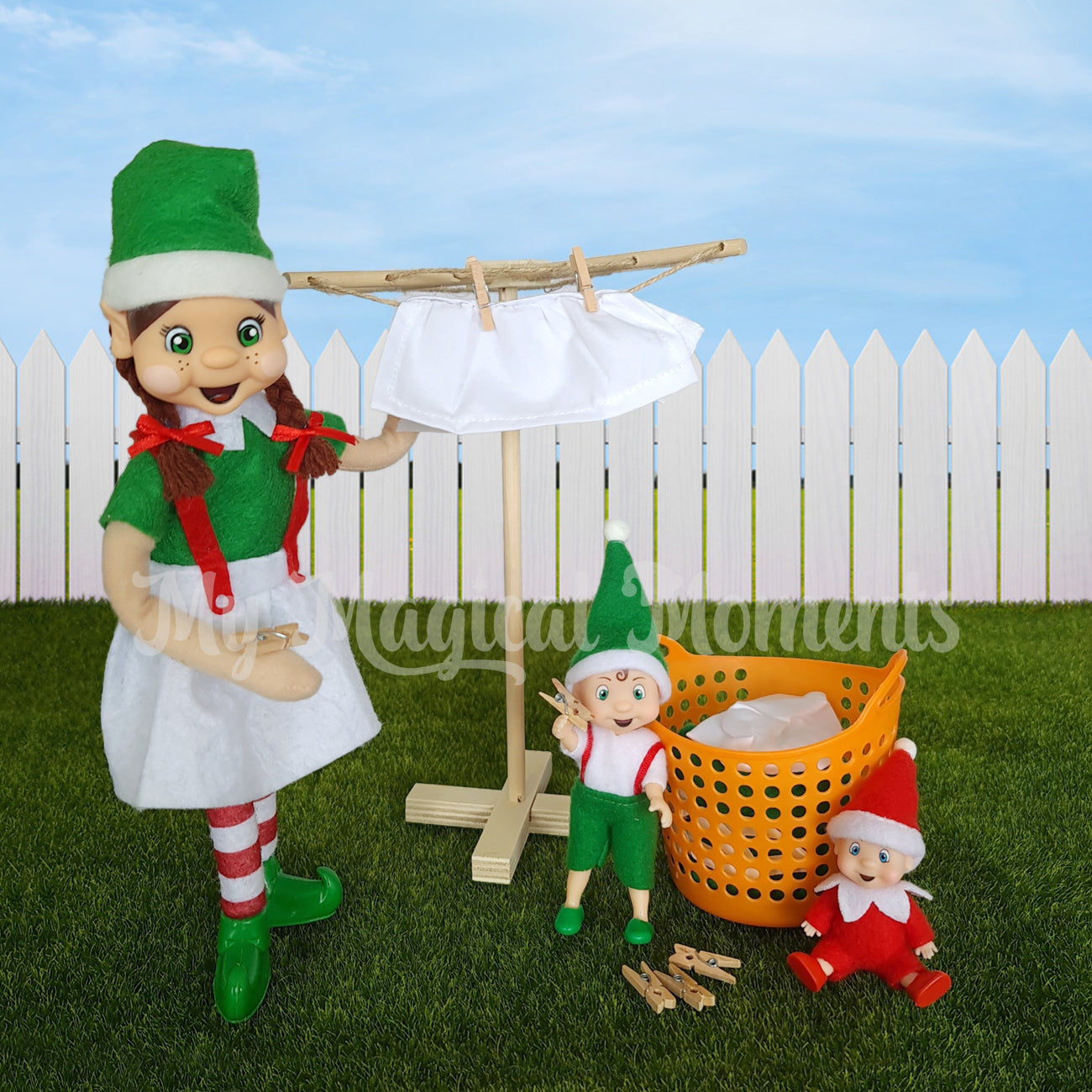 Elf hanging out washing on her miniature clothesline and elf children