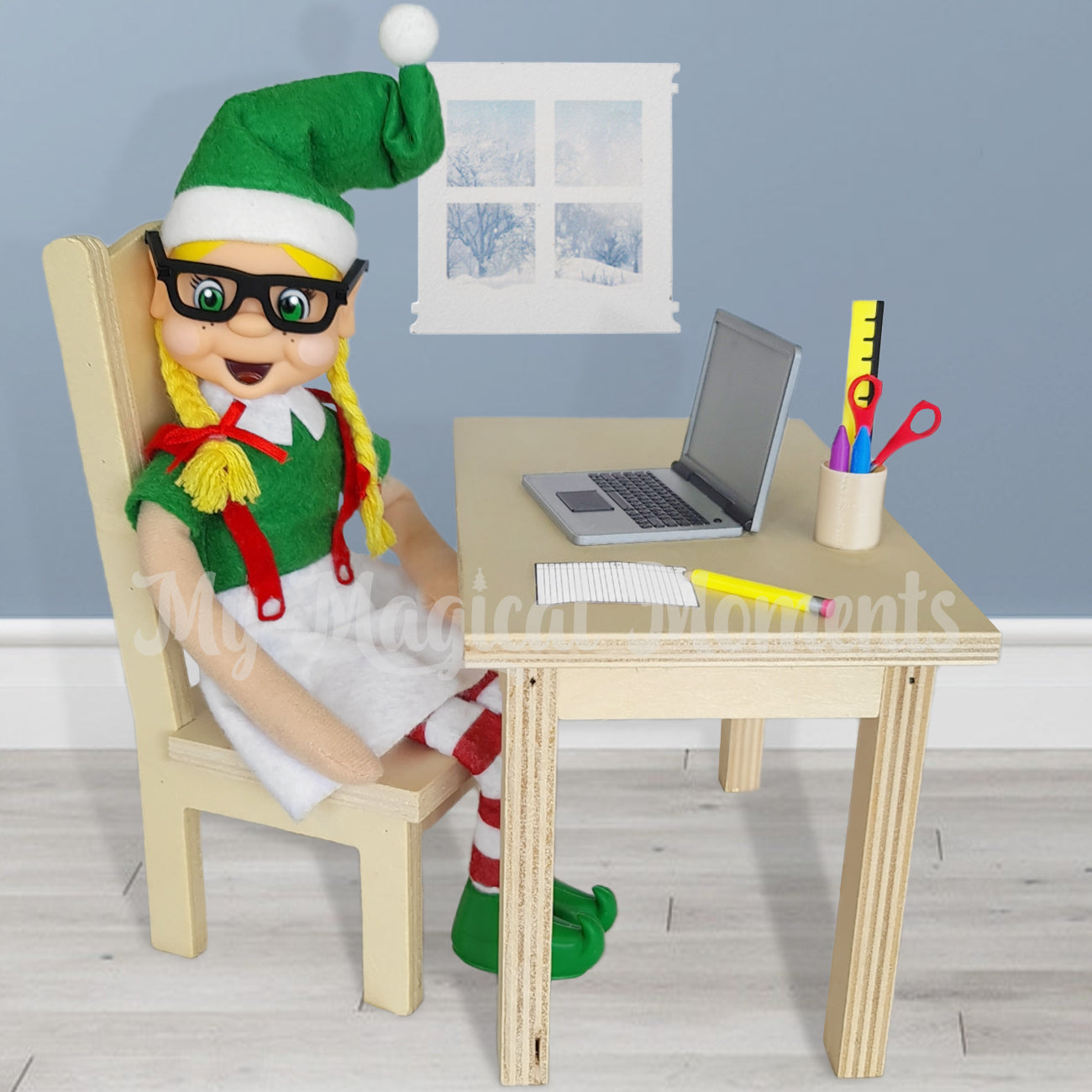 Blonde Hair Elf wearing miniature glasses. Sitting at a wooden desk working on a little laptop, stationery set can be scene and a window
