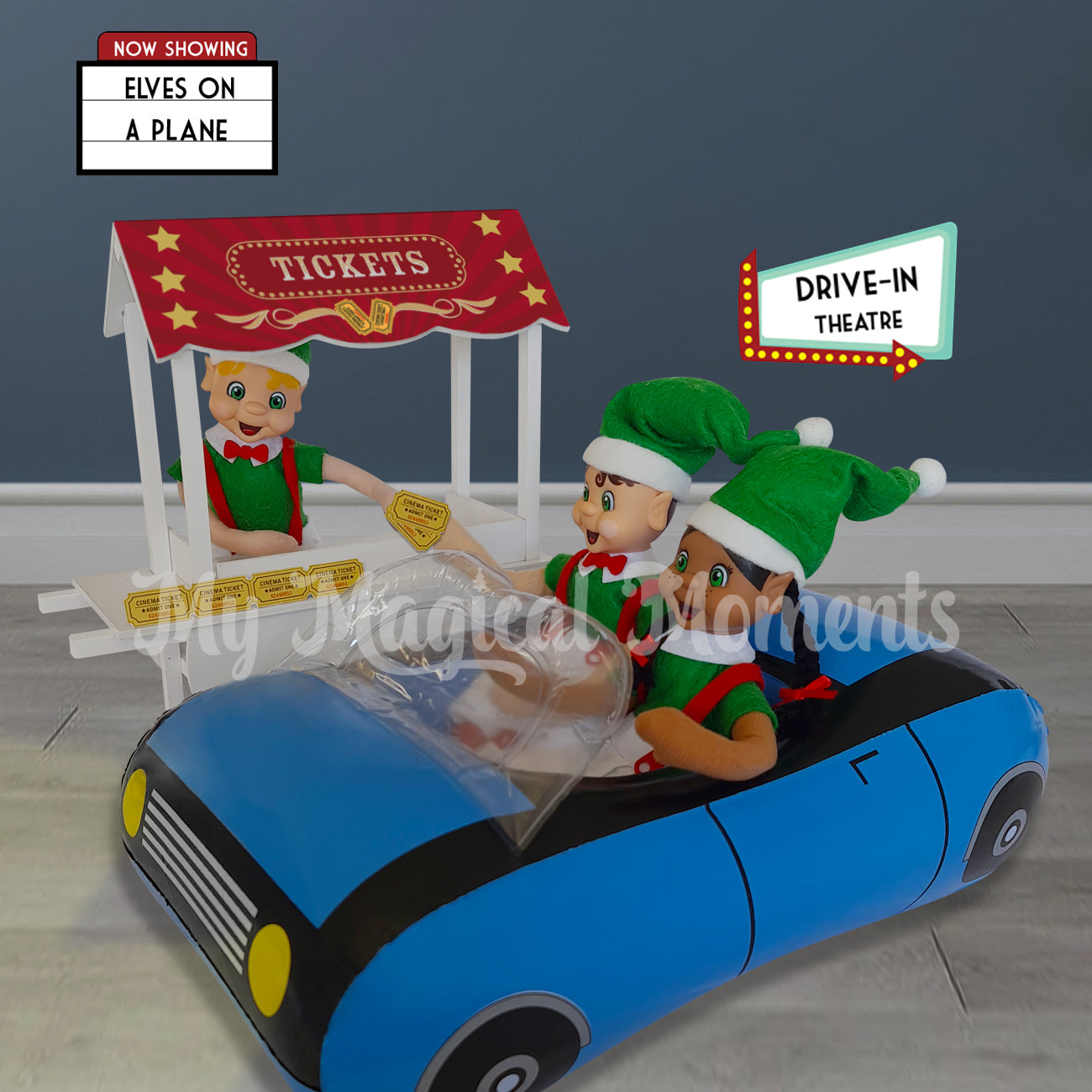 elves in a car buying tickets from a ticket booth for a drive in movie