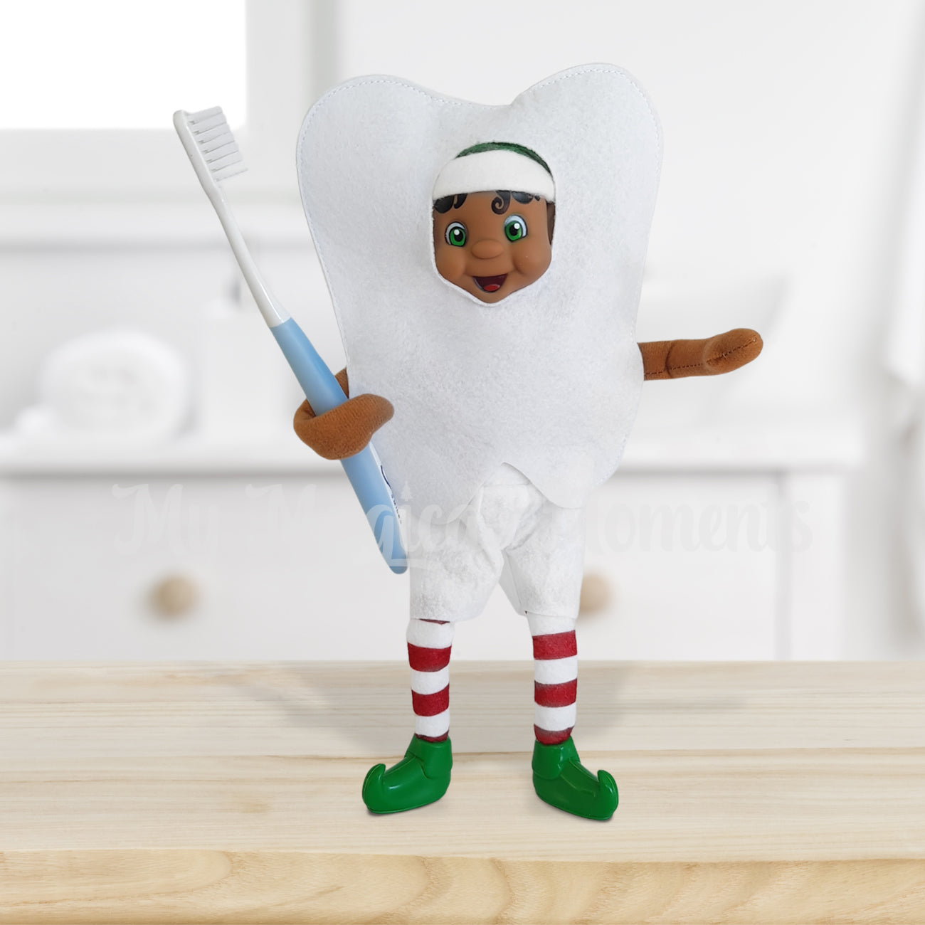 Elf dressed in a tooth costume holding a toothbrush in a bathroom