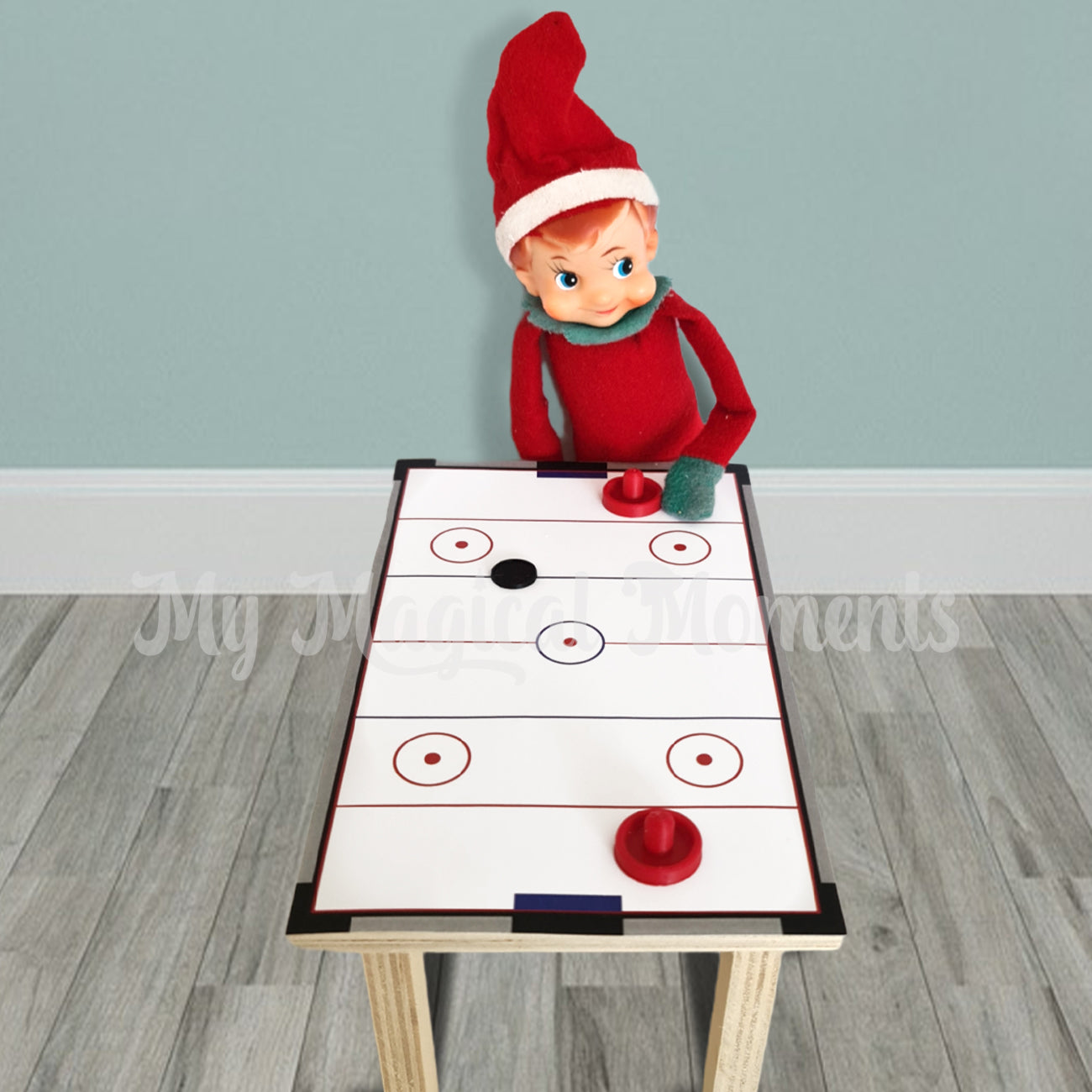 Elf playing air hockey on a table