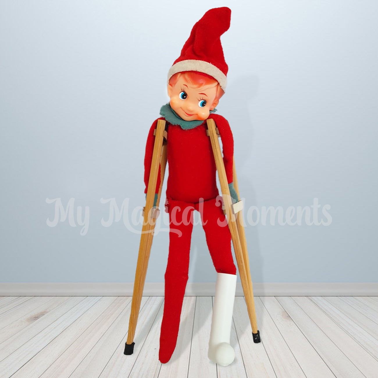 Vintage elf using elf sized crutches and a miniature leg cast
