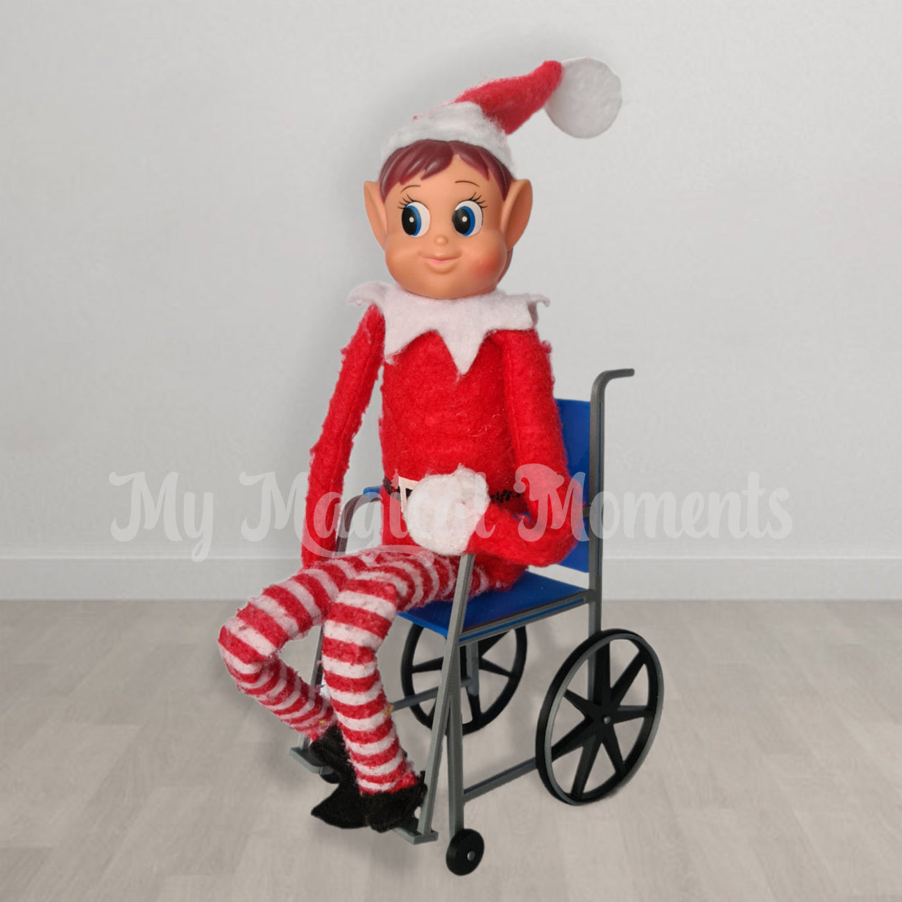 Elves behavin badly sitting in a blue elf sized wheelchair