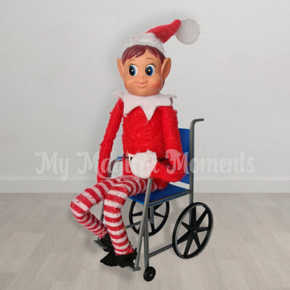 Elves behavin badly sitting in a blue elf sized wheelchair