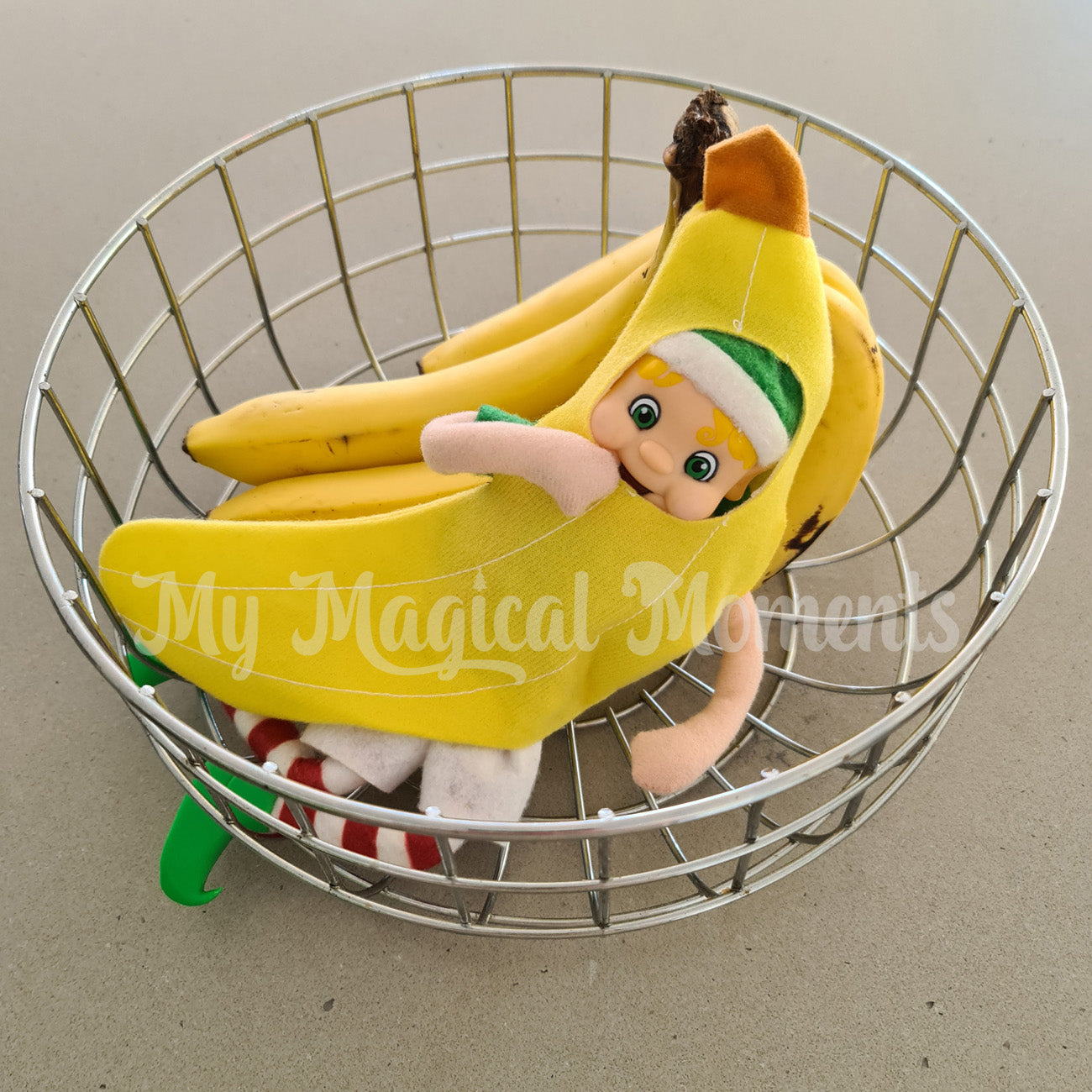 Elf friends dressed as a banana hiding in a fruit bowl