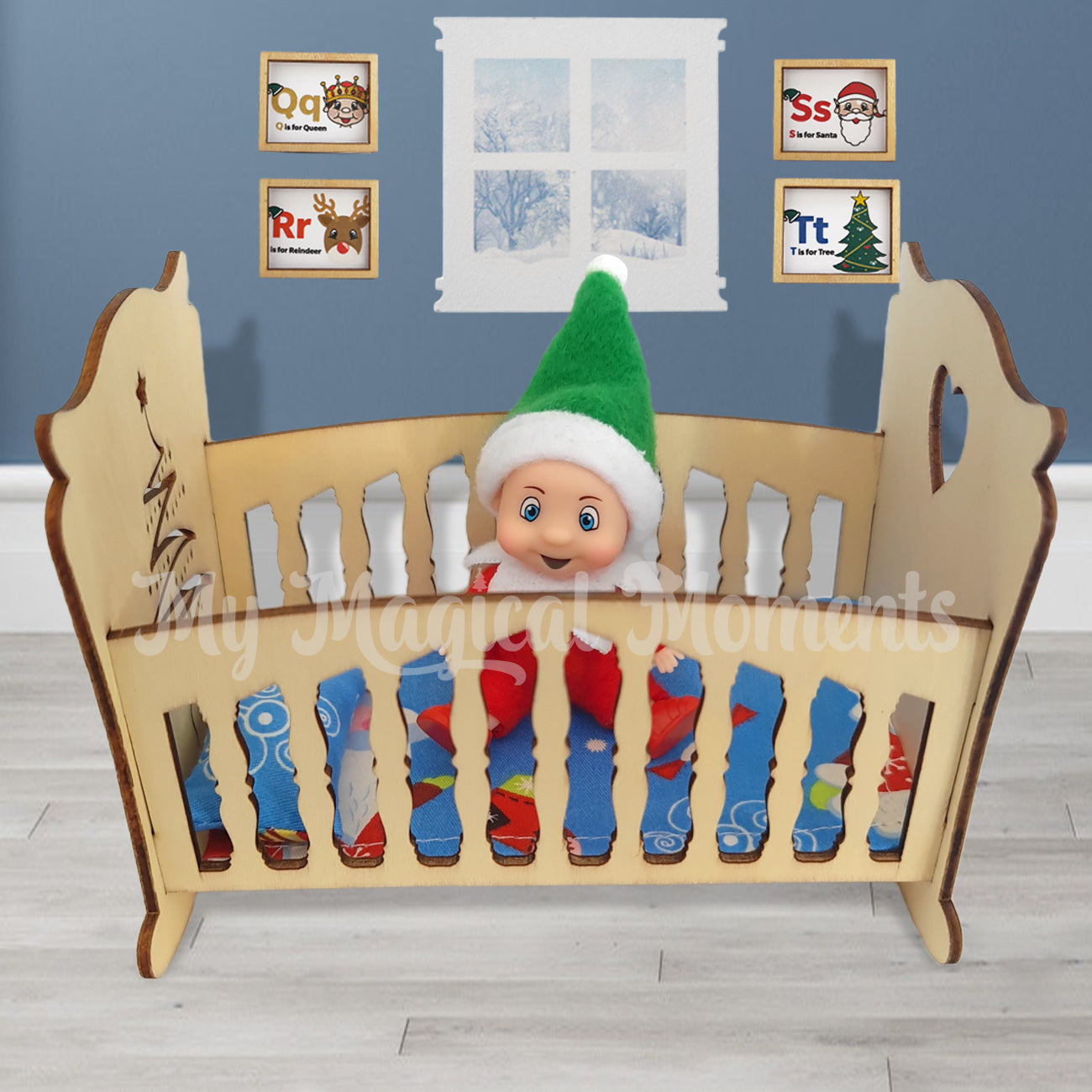 elf baby sitting in miniature cot