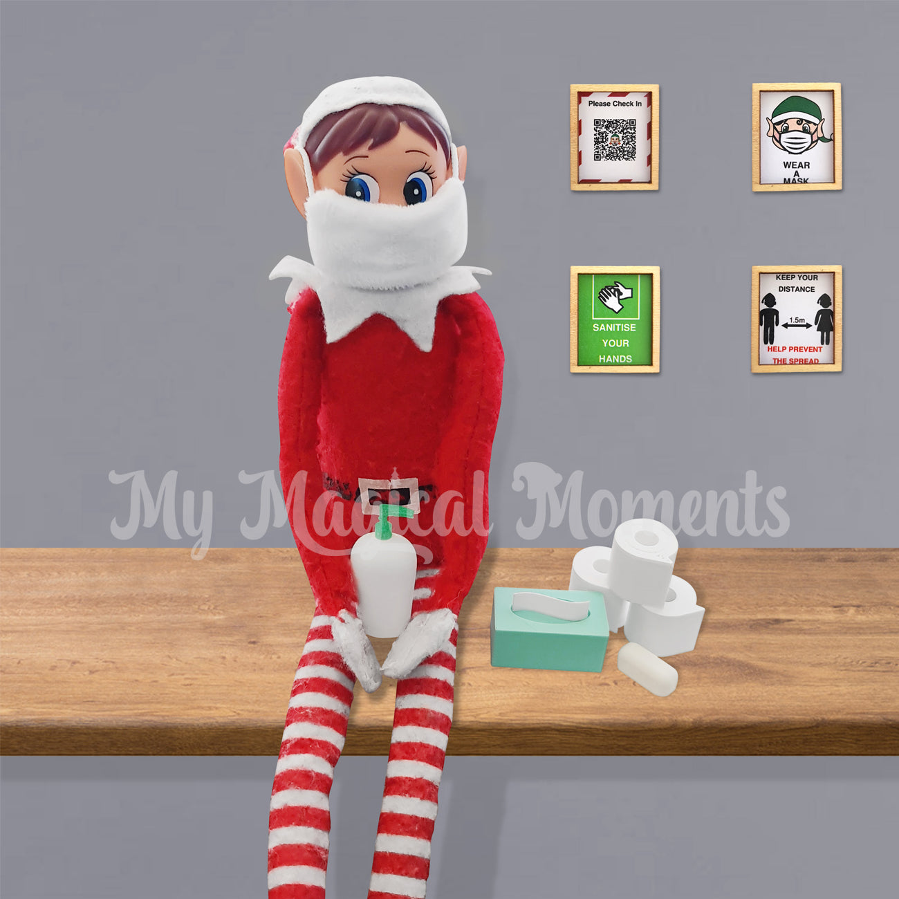 Elves behavin badly sitting on a shelf wearing a face mask, holding a miniature bottle of sanitiser. Next to her toilet paper, tissues and soap