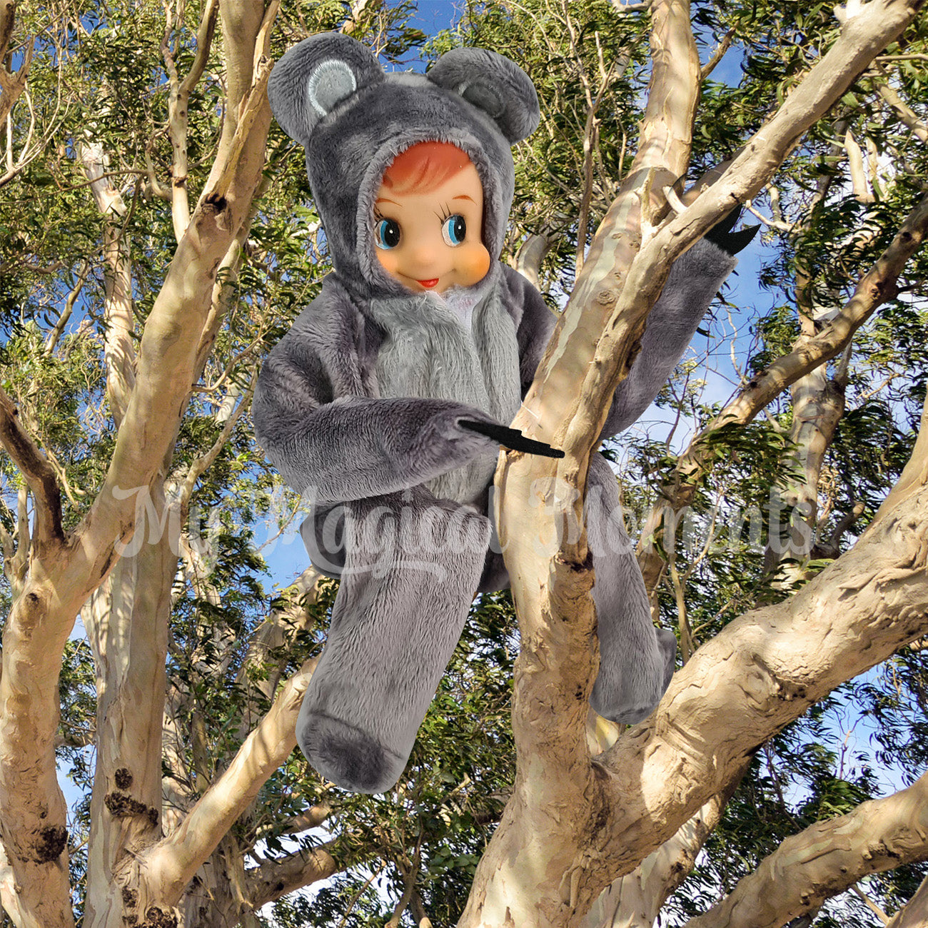 elf wearing a koala outfit in a tree